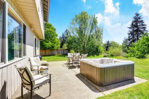 Backyard concrete patio with hot tub | Poly Projacking