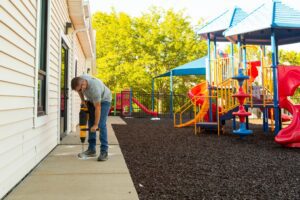 image of a man polyjacking a preschool sidewalk