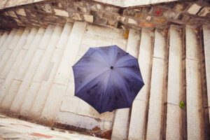 Concrete Repair - image of a man covering himself from the rain