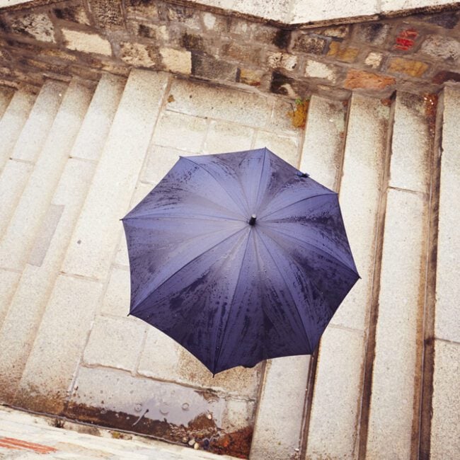 Concrete Repair - image of a man covering himself from the rain