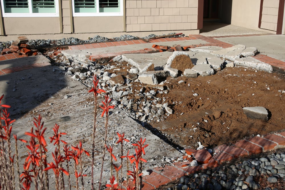 Concrete leveling - image of a cement driveway being demolished.